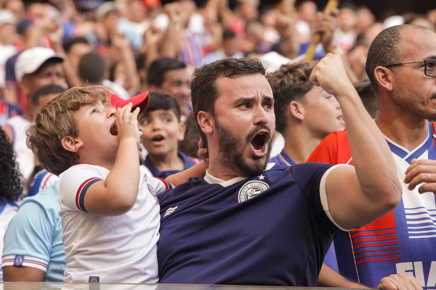 Real fans cheering together at a live sporting event